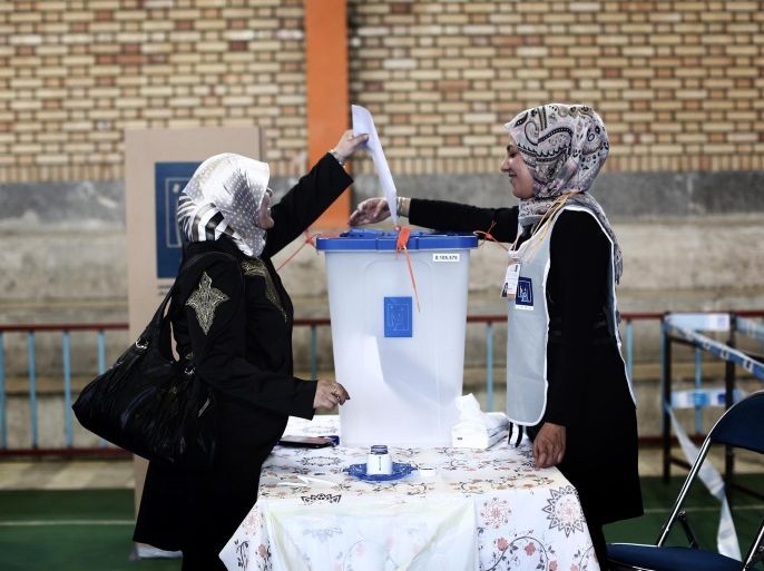 An Iraqi woman residing in Iran casts her ballot for Iraq's parliamentary elections at a polling station in southern Tehran on April 27, 2014. Iraqi residents in Iran head to the polls today as in Iraq the polls will open on April 30, with little sign of any respite in the bloodshed, and the country still looking to rebuild after decades of conflict and sanctions. AFP PHOTO/BEHROUZ MEHRI