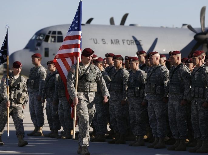 Members of the U.S. Army 173rd Airborne Brigade attend a welcome ceremony upon their arrival at a Lithuanian air force base in Siauliai, Lithuania, Saturday, April 26, 2014. US troops arrived Saturday in Lithuania to participate in NATO maneuvers, at a time of increased tension in nearby Ukraine.(AP Photo/Mindaugas Kulbis)