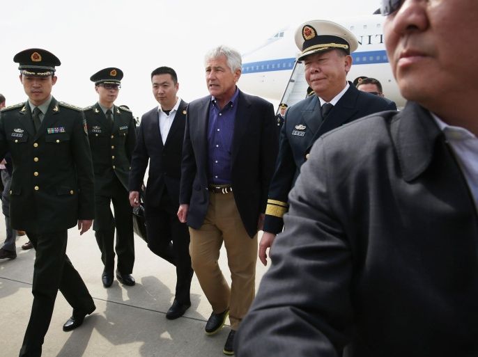 QINGDAO, CHINA - APRIL 07: Escorted by Chinese military personnel, U.S. Secretary of Defense Chuck Hagel arrives at Qingdao International Airport April 7, 2014 in Qingdao, China. Secretary Hagel is on an Asian trip, the fourth time since he took office, to Japan, China and Mongolia. He will tour the Chinese People's Liberation Army Navy aircraft carrier Liaoning at Yuchi Naval Base in Qingdao before he continues his trip to Beijing.