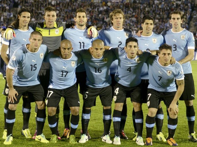 FILE - In this Oct. 15, 2013 file photo, Uruguay soccer team poses prior to the start the 2014 World Cup qualifying soccer match between Uruguay and Argentina in Montevideo, Uruguay. Foreground from left: Diego Perez, Egidio Arevalo, Maximiliano Pereira, Jorge Fucile and Cristian Rodriguez. Background from left: Edinson Cavani, Fernando Muslera, Christian Stuani, Diego Lugano, Luis Suarez and Diego Godin. (AP Photo/Matilde Campodonico, File)