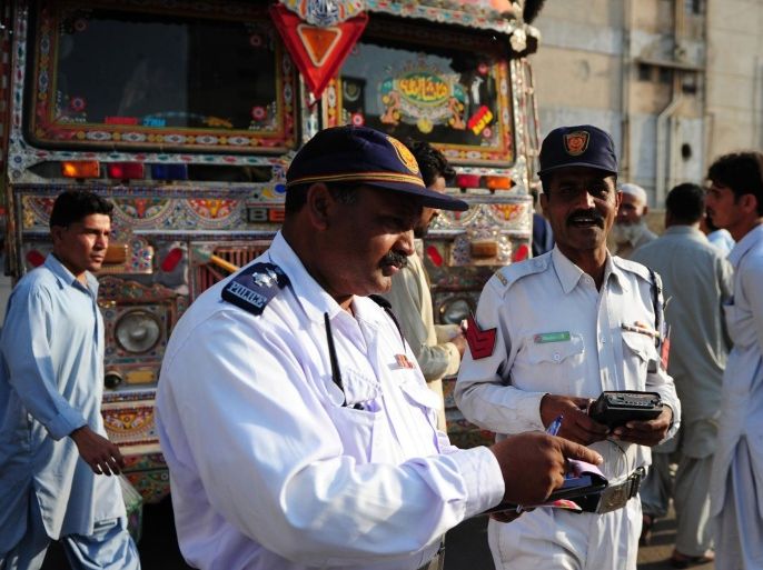 A Pakistani traffic police officer holds a music player that was removed from a passenger bus in Karachi on February 20, 2014. Traffic police in the Pakistani city of Karachi said they have launched a campaign to stop music being played in public transport due to complaints from women. The authorities denied the move was in response to a reported warning from the Taliban, who consider music sinful according to their fundamentalist interpretation of Islam. AFP PHOTO/Asif HASSAN