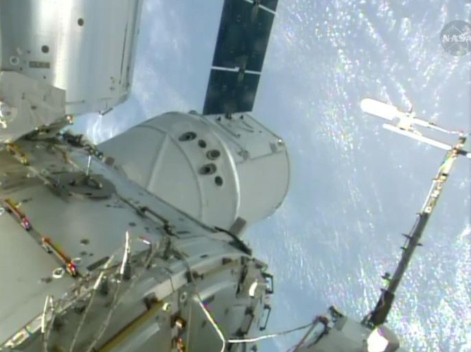 In this Sunday, April 20, 2014, image made from a frame grabbed from NASA-TV, the SpaceX Dragon resupply capsule is seen after being berthed on to the International Space Station. At the time of this frame grab the capsule was traveling over Brazil at 10:14 a.m. EDT Sunday. (AP Photo/NASA-TV)