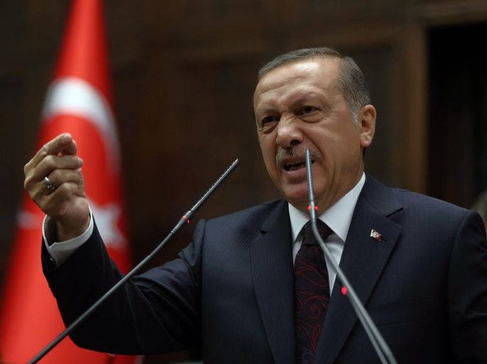 Turkish Prime Minister Recep Tayyip Erdogan addresses his supporters and lawmakers at the parliament in Ankara, Turkey, Tuesday, April 8, 2014.(AP Photo