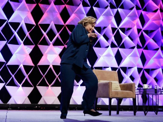 LAS VEGAS, NV - APRIL 10: Former Secretary of State Hillary Clinton ducks after a woman threw an object toward her while she was delivering remarks at the Institute of Scrap Recycling Industries conference on April 10, 2014 in Las Vegas, Nevada. Clinton is continuing on a speaking tour this week with the stop at the recycling industry trade conference.