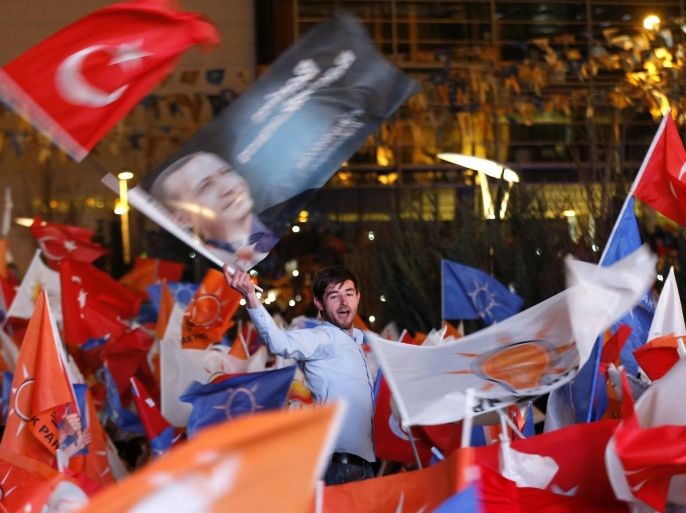 Supporters of Turkey's Prime Minister Tayyip Erdogan celebrate their election victory in front of the party headquarters in Ankara March 31, 2014. REUTERS/Umit Bektas