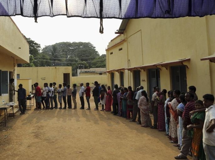 People line up outside a polling station to cast their votes in Bangalore, India, Thursday, April 17, 2014. Indians cast ballots Thursday on the biggest day of voting in the country's weeks long general election, streaming into polling stations even in areas where leftist rebels threatened violence over the plight of India's marginalized and poor. Nationwide voting began April 7 and runs through May 12, with results for the 543-seat lower house of Parliament to be announced four days later. (AP Photo/Aijaz Rahi)