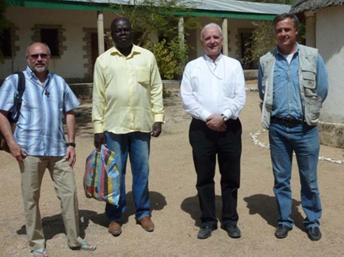 This photo released by Vicenza Diocesi, Saturday April 5, 2014 shows Vicenza Bishop Beniamino Pizziol, second from right, flanked by father Gianantonio Alllegri, left, and Giampaolo Marta, right, during a visit in Jericho, near Maroua, Cameroon, on Jan. 2014. Officials say two Italian priests and a Canadian nun working as missionaries in northern Cameroon have been abducted. Italy's foreign ministry said the abduction occurred during the night between Friday and Saturday about 30 kilometers (20 miles) from the border with Nigeria. It identified the priests as Giampaolo Marta and Gianantonio Allegri, but declined to give other details, including the Canadian's identity, to avoid compromising efforts for the missionaries' release.( AP Photo/Vicenza Diocese)