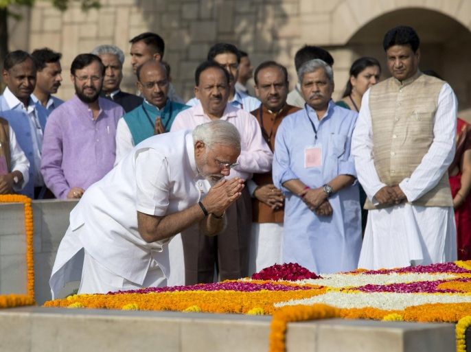 Indian Prime Minister-designate and Hindu nationalist Bharatiya Janata Party leader Narendra Modi pays his respects at Rajghat, the memorial of Mahatma Gandhi, in New Delhi, India, Monday, May 26, 2014. Modi, 63, will be sworn-in as the India's Prime Minister on Monday evening by President Pranab Mukherjee at the forecourt of the Indian presidential palace. (AP Photo /Manish Swarup)