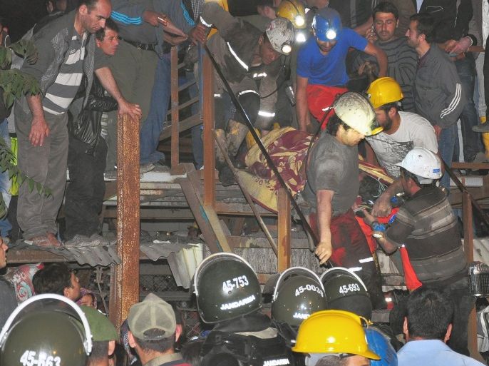 Miners carry a rescued friend after an explosion and fire at a coal mine killed at least 17 miners and left up to 300 workers trapped underground, in Soma, in western Turkey, Tuesday, May 13, 2014, a Turkish official said. Twenty people were rescued from the mine but one later died in the hospital, Soma administrator Mehmet Bahattin Atci told reporters. The town is 250 kilometers (155 miles) south of Istanbul. The death toll was expected to rise.(AP Photo/IHA) TURKEY OUT