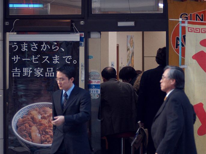 People walk by eat in at Yoshinoya, a fast-food restaurant serving beef bowls (sliced beef over rice) in Tokyo, Japan, Thursday 25 December 2003. After a cow on a Washington state farm tested positive for mad cow disease, Yoshinoya insisted that the meat they offer was tested safe by International Office of Epizootics (OIE) and World Health Organization (WHO) although this restaurant chain uses 99 percent of the US beef. They says they have beef stock enough for next one month and might have to discuss about inporting Australian beef if needed later on in the near future. Japan is the largest overseas market for US beef. EPA