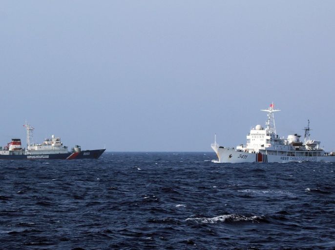A picture made available 16 May 2014 shows a Chinese coast guard vessel (R) and a Vietnamese coast guard vessel (L) near the area of China's oil drilling rig in disputed waters in the South China Sea, off shore Vietnam, 14 May 2014. Vietnam accused Chinese boats of repeatedly ramming Vietnamese vessels near disputed waters in the South China Sea where China has placed an oil drilling platform near the Paracel Islands.