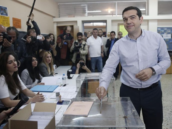 Greek left-wing opposition leader Alexis Tsipras casts his vote at a voting center, in Athens, Sunday, May 18, 2014. Greece's rickety coalition government faces its first electoral test in local and regional voting Sunday — followed in a week by the nationwide European parliamentary elections that the left-wing opposition has billed as a referendum on the country's bailout.(AP Photo/Petros Giannakouris)