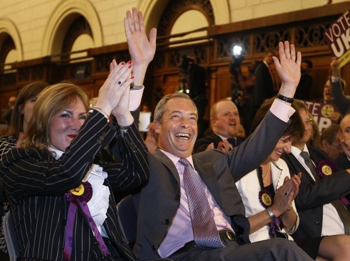 Nigel Farage leader of Britain's UK Independence Party (UKIP) celebrates as he hears the results of the south east region European Parliamentary Election vote at the Guildhall in Southampton, England, Monday, May 26, 2014. From Portugal to Finland, voters of 21 nations cast ballots Sunday to decide the makeup of the next European Parliament and help determine the European Union’s future leaders and course. (AP Photo/Kirsty Wigglesworth)