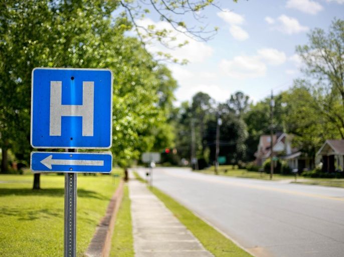 In this April 25, 2014 photo, a sign points the way to Flint River Hospital which closed its emergency room last year, in Montezuma, Ga. Residents must now drive 20 or 30 miles on slow country roads to the nearest hospital. Alarmed by hospital closures, health officials in Georgia are changing rules to let stressed rural hospitals become expanded emergency rooms that can also handle routine childbirths or outpatient surgery. (AP Photo/David Goldman)