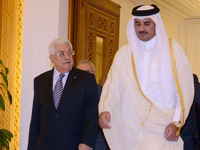 A handout picture released by the Palestinian Press Office (PPO) shows Palestinian leader Mahmud Abbas (L) being welcomed by the Emir of Qatar Sheikh Tamim bin Hamad al-Thani before a meeting on May 5, 2014 in Doha, Qatar. AFP