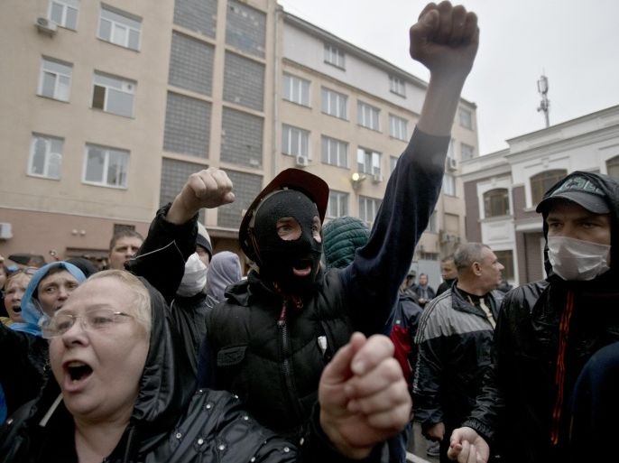 Pro-Russian protesters celebrate at a police station building in Odessa, Ukraine, Sunday, May 4, 2014. Several prisoners that were detained during clashes that erupted Friday between pro-Russians and government supporters in the key port on the Black Sea coast were released under the pressure of protesters that broke into a local police station and received a hero's welcome by crowds. (AP Photo/Vadim Ghirda)