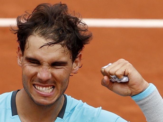 Spain's Rafael Nadal clenches his fist after defeating Austria's Dominic Thiem during the second round match of the French Open tennis tournament at the Roland Garros stadium, in Paris, France, Thursday, May 29, 2014. Nadal won 6-2, 6-2, 6-3. (AP Photo/Darko Vojinovic)