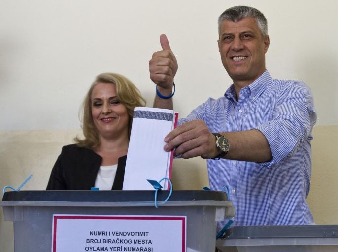 Kosovo's prime minister Hashim Thaci joined by his wife Lumnije casts his ballot at a polling station in the Kosovo capital of Pristina Sunday, June 8, 2014. Kosovo is voting in snap parliamentary polls, amid dissatisfaction with corruption and unemployment. Incumbent Hashim Thaci is seeking a third term as prime minister, but faces a tough fight from the opposition. (AP Photo/Visar Kryeziu)