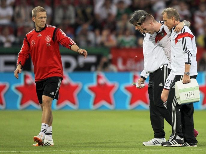 Germany's Marco Reus (2-R) is injured and escorted off the pitch during the international friendly soccer match between Germany and Armenia at the Coface Arena in Mainz, Germany, 06 June 2014. Germany prepares for the FIFA World Cup 2014 taking place in Brazil from 12 June to 13 July 2014.