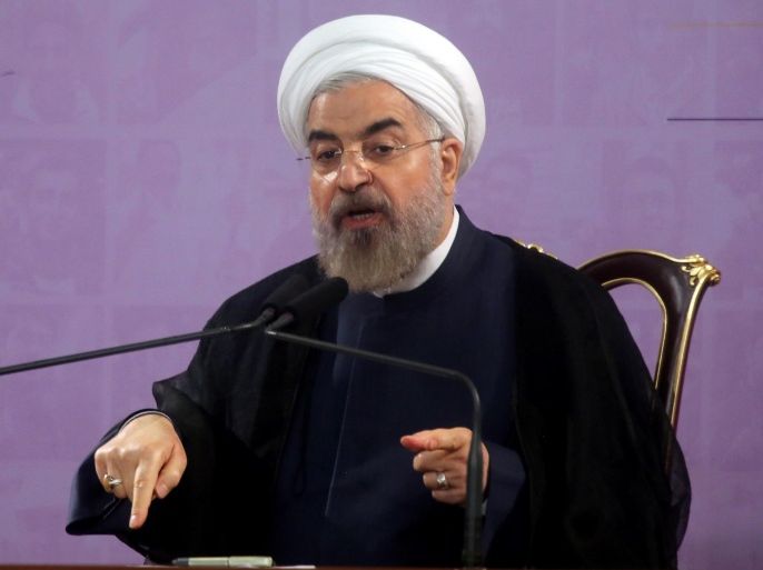 Iranian President Hassan Rouhani speaks during a press conference in the capital Tehran on June 14, 2014. Iran may consider cooperating with the United States in fighting Sunni extremist fighters in Iraq if Washington acts against them, Rouhani told journalists. AFP PHOTO/ATTA KENARE