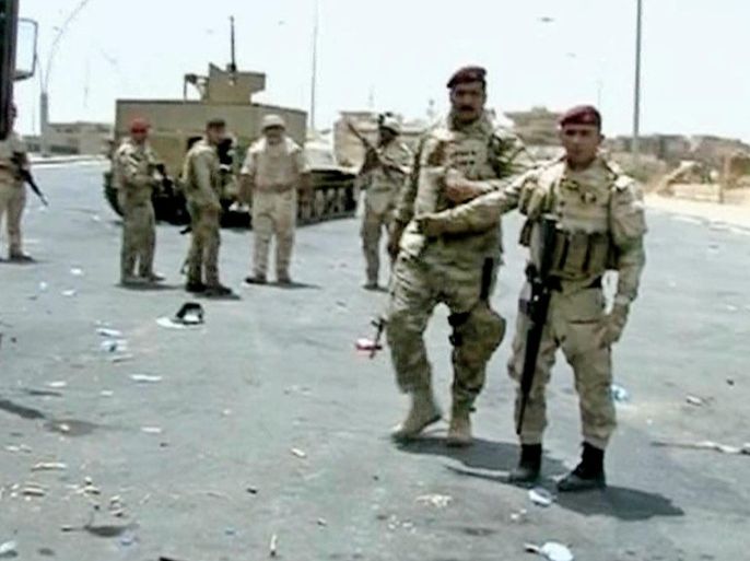 In this Monday, June 9, 2014, image taken from video obtained from the Iraqi military, which has been authenticated based on its contents and other AP reporting, armed Iraqi soldiers take their positions during clashes with militants in the northern city of Mosul, Iraq. Insurgents pressed their efforts Tuesday to seize effective control of Mosul after Iraqi security forces abandoned their posts and militants overran the provincial government headquarters and other key buildings, dealing a serious blow to Baghdad’s attempts to tame a widening insurgency. (AP Photo/Iraqi Military via AP video)