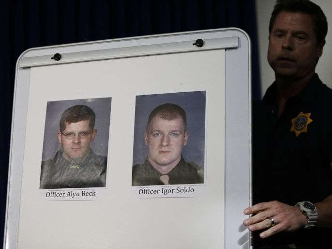 Pictures of Las Vegas Metropolitan Police Officers Alyn Beck, left, and Igor Soldo are seen a a news conference Sunday, June 8, 2014 in Las Vegas. The two officers were killed in an ambush while eating lunch. (AP Photo/John Locher)