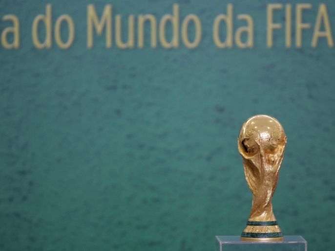 The 2014 World Cup trophy sits on top of a glass podium before the start of a ceremony at the Planalto presidential palace where FIFA President Sepp Blatter was to present the trophy to Brazil's President Dilma Rousseff, in Brasilia, Brazil, Monday, June 2, 2014. (AP Photo/Eraldo Peres)