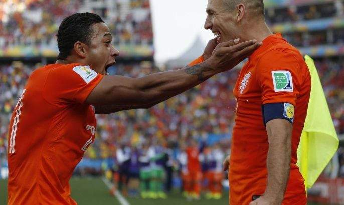 Netherlands' Memphis Depay, left, celebrates with his teammate Arjen Robben after scoring his side's second goal during the group B World Cup soccer match between the Netherlands and Chile at the Itaquerao Stadium in Sao Paulo, Brazil, Monday, June 23, 2014. The Dutch team beat Chile 2-0 to top Group B. (AP Photo/Frank Augstein)