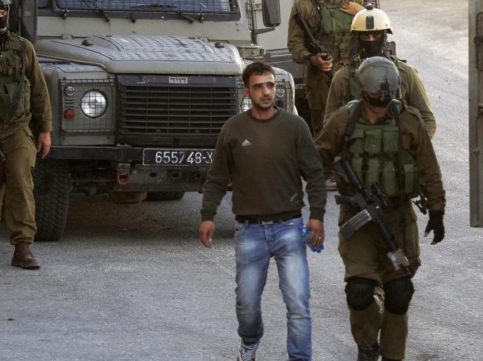 Israeli soldier detain a Palestinian man during a military operation to search for three missing Israeli teenagers, in the West Bank city of Hebron, 14 June 2014. The three hitched a ride near a Jewish settlement on late on 12 June and have not been heard from since. Prime Minister Benjamin Netanyahu held an assessment of the situation with top security officials. 'Israel holds the Palestinian Authority responsible for the well-being of the missing', Netanyahu's office said.