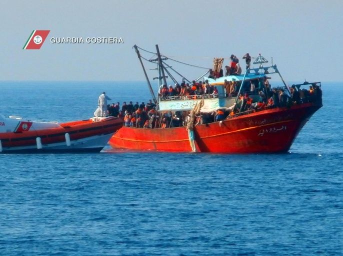 A handout picture released by the Italian Coast Guard shows a coast guard boat next to a boat (R) carrying 281 refugees, at sea off the coast of Calabria Region, Italy, 14 June 2014. Nearly 300 migrants who said they were refugees from Syria have been rescued off the Italian coast, officials. The coast guard said two patrol boats and a a tax police vessel picked up 281 people from a 20-metre fishing boat some 150 kilometres away from the coast of Calabria, the region that forms the tip of Italy's boot. The migrants were spotted in the Mediterranean between Greece and Italy. Among the rescued passengers were 93 children and six women, some of who were in a precarious medical condition, the coast guard said. EPA/ITALIAN COASTGUARD / HANDOUT
