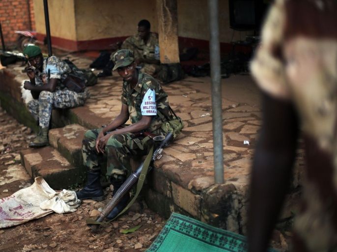 In this May 24 2014 picture, ex-Seleka rebels sit at their base in to Bambari, Central African Republic. In a report released Tuesday June 24, 2014, the International Federation for Human Rights said that the tit-for-tat attacks against rival religious groups in Central African Republic threaten to create the conditions of a genocide reminiscent of Bosnia in the 1990s and requires swift efforts by the government and the international community to stop the violence. The 88-page report details the atrocities committed by both sides in this impoverished country and urged the re-establishment of a legal and penal system to stop the wave of crime and violence and begin trying those behind the massacres.(AP photo/Jerome Delay)