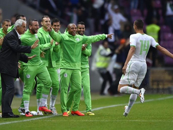 Algeria's midfielder Nabil Bentaleb (R) celebrates with teammate after scoring his team's first goal during the friendly football match between Algeria and Romania on June 4, 2014, at the Geneva Stadium in Geneva, ahead of the upcoming 2014 FIFA World Cup in Brazil. AFP PHOTO / FABRICE COFFRINI