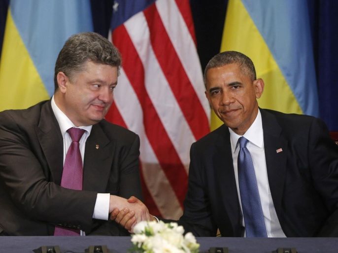 U.S. President Barack Obama, right, shakes hands with Ukraine president-elect Petro Poroshenko in Warsaw, Poland, Wednesday, June 4, 2014. (AP Photo/Charles Dharapak)