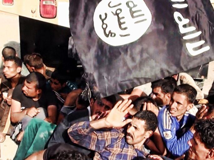 This image posted on a militant website on Saturday, June 14, 2014, which has been verified and is consistent with other AP reporting appears to show militants from the al-Qaida-inspired Islamic State of Iraq and the Levant (ISIL) with captured Iraqi soldiers wearing plain clothes after taking over a base in Tikrit, Iraq. The Islamic militant group that seized much of northern Iraq has posted photos that appear to show its fighters shooting dead dozens of captured Iraqi soldiers in a province north of the capital Baghdad. Iraq's top military spokesman Lt. Gen. Qassim al-Moussawi confirmed the photos’ authenticity on Sunday and said he was aware of cases of mass murder of Iraqi soldiers. (AP Photo via militant website)