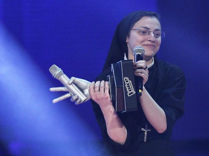 Sister Cristina Scuccia reacts after winning the Italian State RAI TV program's final 'The Voice of Italy', in Milan on June 6, 2014. The 25-year-old nun Cristina won the talent show thanks to her habit-clad performances but also by having on her side the critics, who say her popularity stems from novelty value. AFP PHOTO/Marco BERTORELLO