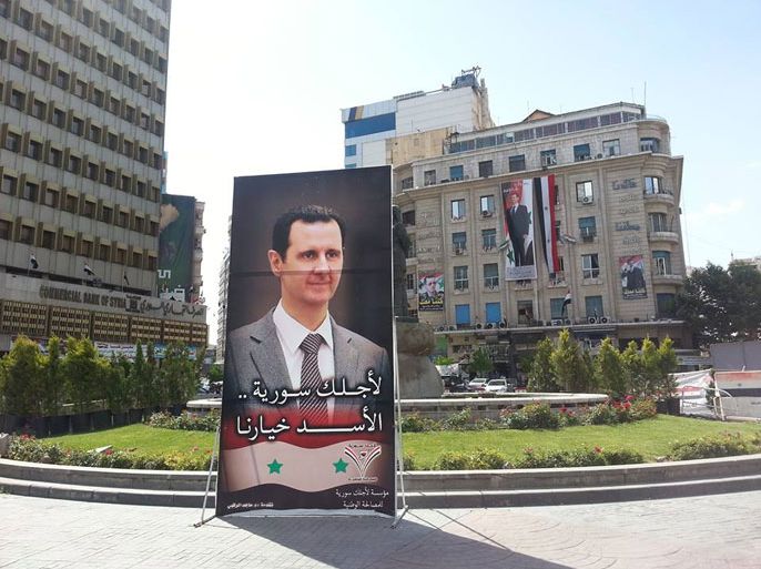 إعلانات المرشح للرئاسة بشار الأسد في دوار المحافظة وسط العاصمة دمشق.jpg