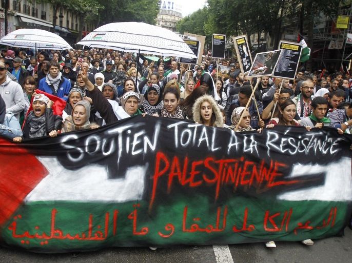 Thousands of pro-Palestinian demonstrators holding banners and chanting anti Israeli slogans walk in Paris, Sunday July 13, 2014, to protest against the Israeli army's bombings in the Gaza strip. Banner reads: Total Support to Palestinan Resistance. About 10,000 pro-Palestinian protesters marched through eastern Paris on Sunday demanding an end to Israeli strikes on Gaza, and accusing Western leaders of not doing enough to stop them. Israel has launched more than 1,300 air strikes since the offensive began, military spokesman Lt. Col. Peter Lerner said Sunday. Palestinian militants have launched more than 800 rockets at Israel, including 130 in the last 24 hours, the Israeli military said Sunday. (AP Photo/Remy de la Mauviniere)