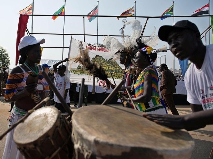 A dancing troupe play their traditional instruments during celebrations at the Dr. John Garang Mausoleum During Independence day on July 9, 2014, celebrating the third anniversary of independence. Thousands of South Sudanese waved flags at military parades to mark three years of independence on July 9, despite little to celebrate in a war-torn young nation ravaged by ethnic atrocities and threatened with famine. The streets of the capital were lined with banners proclaiming 'One People, One Nation', as the government of President Salva Kiir put on a show of force with a military parade and speeches intended to celebrate the breakaway from the repressive government in Khartoum. AFP PHOTO / CHARLES LOMODONG