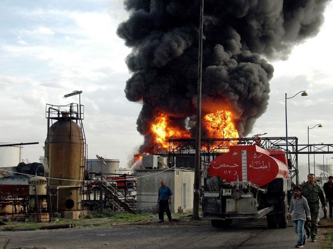 Syrian firemen try to extinguish a burning fuel tank at an oil refinery in the province of Homs, Syria, 23 November 2013, which was set ablaze by mortars fired by what local sources claim were 'terrorist groups'. No casualties were reported. Extremist rebels from the Islamic Army group and the al-Qaeda-linked al-Nusra Front were reported to have taken control of a major oil field in the eastern province of Deir al-Zour, an opposition watchdog said. Syriaâs oil sector has been at standstill since the crisis erupted. Crude oil production that was at 380,000 barrels per day (bpd) prior to the conflict has fallen to 20,000 bpd, according to Syrian oil experts.