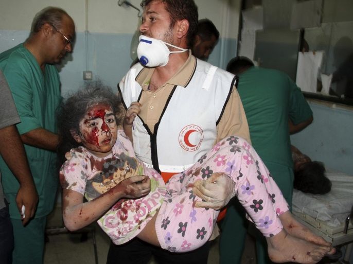 A Palestinian medic carries a wounded girl to a treatment room of Nasser hospital, following an Israeli airstrike at their family house in Khan Younis in the southern Gaza Strip on Wednesday, July 23, 2014. Israeli troops battled Hamas militants on Wednesday near a southern Gaza Strip town as the top U.S. diplomat reported progress in efforts to broker a truce in a war that has so far killed hundreds of Palestinians and tens of Israelis. (AP Photo/Hatem Ali)