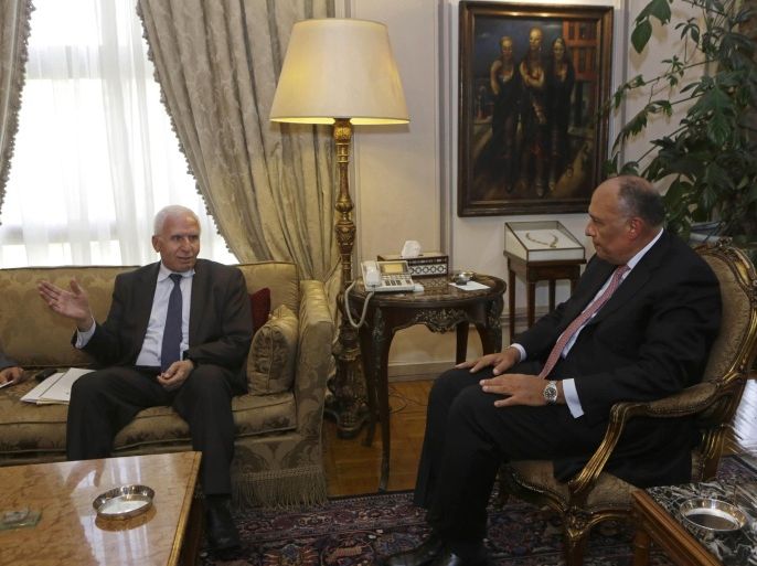 Azzam al-Ahmad, left, a member of the Palestinian Fatah Central Committee in charge of Fatah-Hamas reconciliation affairs, meets with Egyptian Foreign Minister Sameh Shukri, at the Egyptian foreign ministry in Cairo, Egypt, Tuesday, July 22, 2014. The U.S. and Egypt sought Tuesday to find an end to two weeks of bloodshed in the Gaza Strip, and officials raised the possibility of restarting stalled peace talks between Israel and Palestinian authorities as a necessary step to avoid sustained violence. (AP Photo/Amr Nabil)