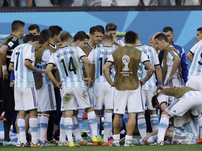 Argentina's players gather before the extra-time during the World Cup round of 16 soccer match between Argentina and Switzerland at the Itaquerao Stadium in Sao Paulo, Brazil, Tuesday, July 1, 2014. (AP Photo/Kirsty Wigglesworth)