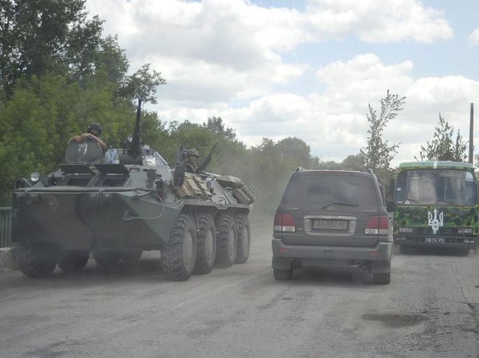 Picture made available 30 June 2014 showing Ukrainian solders transported on an Armoured Personnel Carrier at a position outside Luhansk, Ukraine 29 June 2014. In a bid to end two months of fighting, Ukrainian President Petro Poroshenko and pro-Russian rebels announced earlier on 29 June that the week-long ceasefire that ended Friday was extended until 1900 GMT Monday, 30 June. It was not yet clear if a second extension would be agreed.