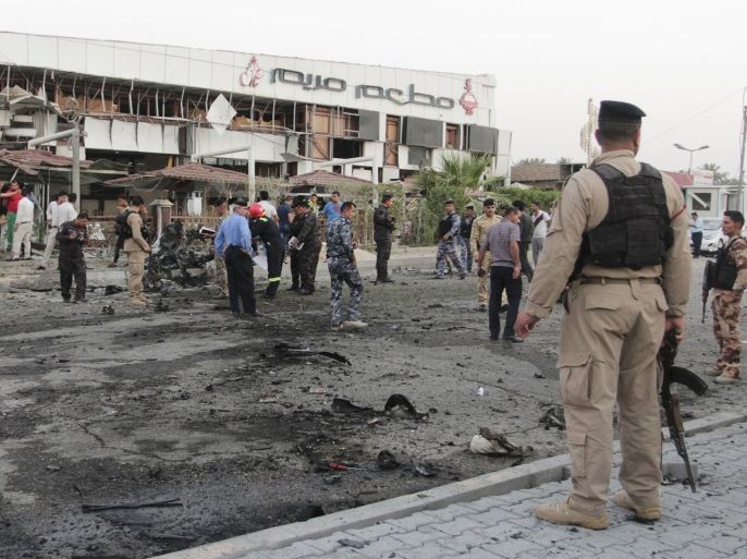 Iraqi security forces inspect the site of a car bomb attack in Basra, southeast of Baghdad, July 5, 2014. At least three people were killed and 15 wounded when two car bomb attacks targeted a restaurant and hotel on Saturday in Basra, southeast of Baghdad, according to hospital sources. REUTERS/Essam Al-Sudani (IRAQ - Tags: CIVIL UNREST POLITICS CRIME LAW CONFLICT)