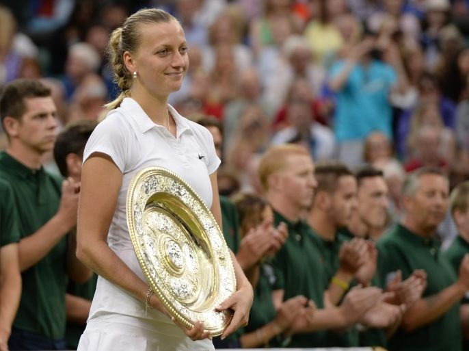 Petra Kvitova of Czech Republic holds the trophy after winning the women's singles final against Eugenie Bouchard of Canada at the All England Lawn Tennis Championships in Wimbledon, London, Saturday, July 5, 2014. (AP Photo/Andy Rain, Pool)