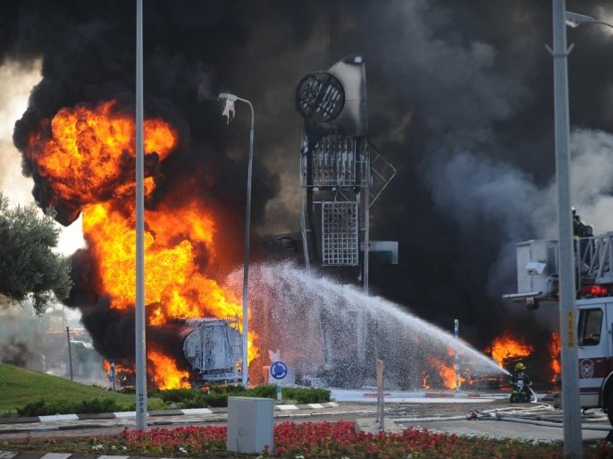 An Israeli firefighter tries to extinguish a petrol station on fire after it was hit by a rocket fired from Gaza in Ashdod, Israel, Friday, July 11, 2014. The attack on the gas station in Ashdod looked to be the most serious attack in Israel in the four days of fighting that has seen Israel deliver a heavy blow to Gaza's Hamas leaders. (AP Photo/Avi Roccah) ISRAEL OUT