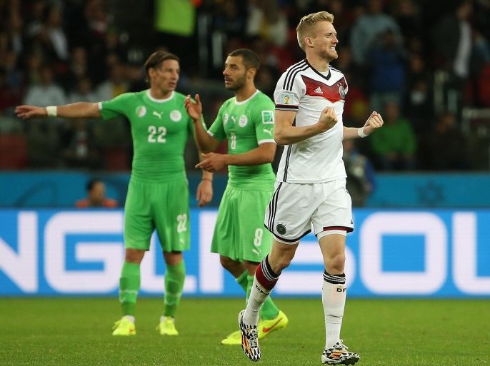 Germany's Andre Schuerrle celebrates after scoring the 1-0 during the FIFA World Cup 2014 round of 16 match between Germany and Algeria at the Estadio Beira-Rio in Porto Alegre, Brazil, 30 June 2014. prior the FIFA World Cup 2014 round of 16 match between Germany and Algeria at the Estadio Beira-Rio in Porto Alegre, Brazil, 30 June 2014. (RESTRICTIONS APPLY: Editorial Use Only, not used in association with any commercial entity - Images must not be used in any form of alert service or push service of any kind including via mobile alert services, downloads to mobile devices or MMS messaging - Images must appear as still images and must not emulate match action video footage - No alteration is made to, and no text or image is superimposed over, any published image which: (a) intentionally obscures or removes a sponsor identification image; or (b) adds or overlays the commercial identification of any third party which is not officially associated with the FIFA World Cup) EPA/OLIVER WEIKEN