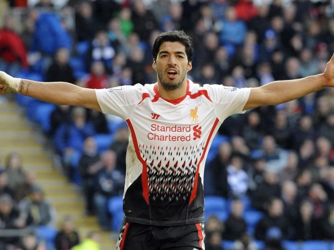Liverpool's Luis Suarez celebrates scoring his third goal against Cardiff City during their English Premier League soccer match at Cardiff City Stadium in Cardiff, Wales, March 22, 2014. REUTERS/Rebecca Naden (BRITAIN - Tags: SPORT SOCCER) NO USE WITH UNAUTHORIZED AUDIO, VIDEO, DATA, FIXTURE LISTS, CLUB/LEAGUE LOGOS OR "LIVE" SERVICES. ONLINE IN-MATCH USE LIMITED TO 45 IMAGES, NO VIDEO EMULATION. NO USE IN BETTING, GAMES OR SINGLE CLUB/LEAGUE/PLAYER PUBLICATIONS. FOR EDITORIAL USE ONLY. NOT FOR SALE FOR MARKETING OR ADVERTISING CAMPAIGNS