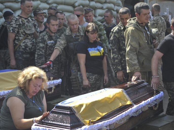 Soldiers of Ukrainian battalion 'Aydar' pay their last respects to fallen colleagues during a funeral ceremony 28 July 2014 in Starobelsk, in the Lugansk area, Ukraine. They were killed during fighting against pro-Russian militants. The Dutch investigators have not able to get to the crash site of the Malaysian Boeing flight MH17 because of fights in the area. Malaysia Airlines Boeing 777 flight MH17 with more than 280 passengers, including 193 Dutch passengers on board crashed in eastern Ukraine on 17 July.