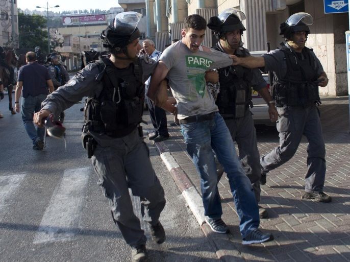 Israeli riot police arrest an Arab Israeli man during clashes that followed a protest against Israel's military offensive on the Gaza Strip, in the northern city of Nazareth, on July 21, 2014. The clashes came as Nazareth and cities in the West Bank observed a general strike to mourn the victims of the Gaza conflict between Israel and Hamas -- the bloodiest since 2009 -- that has cost more than 500 Palestinian lives in two weeks. AFP PHOTO/AHMAD GHARABLI